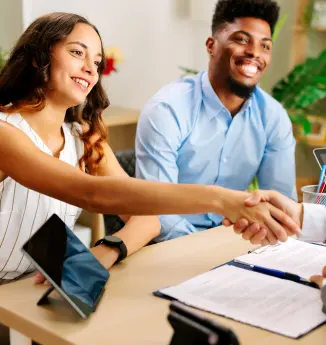 happy-couple-shaking-hands-with-financial-advisor-2025-03-25-19-12-41-utc